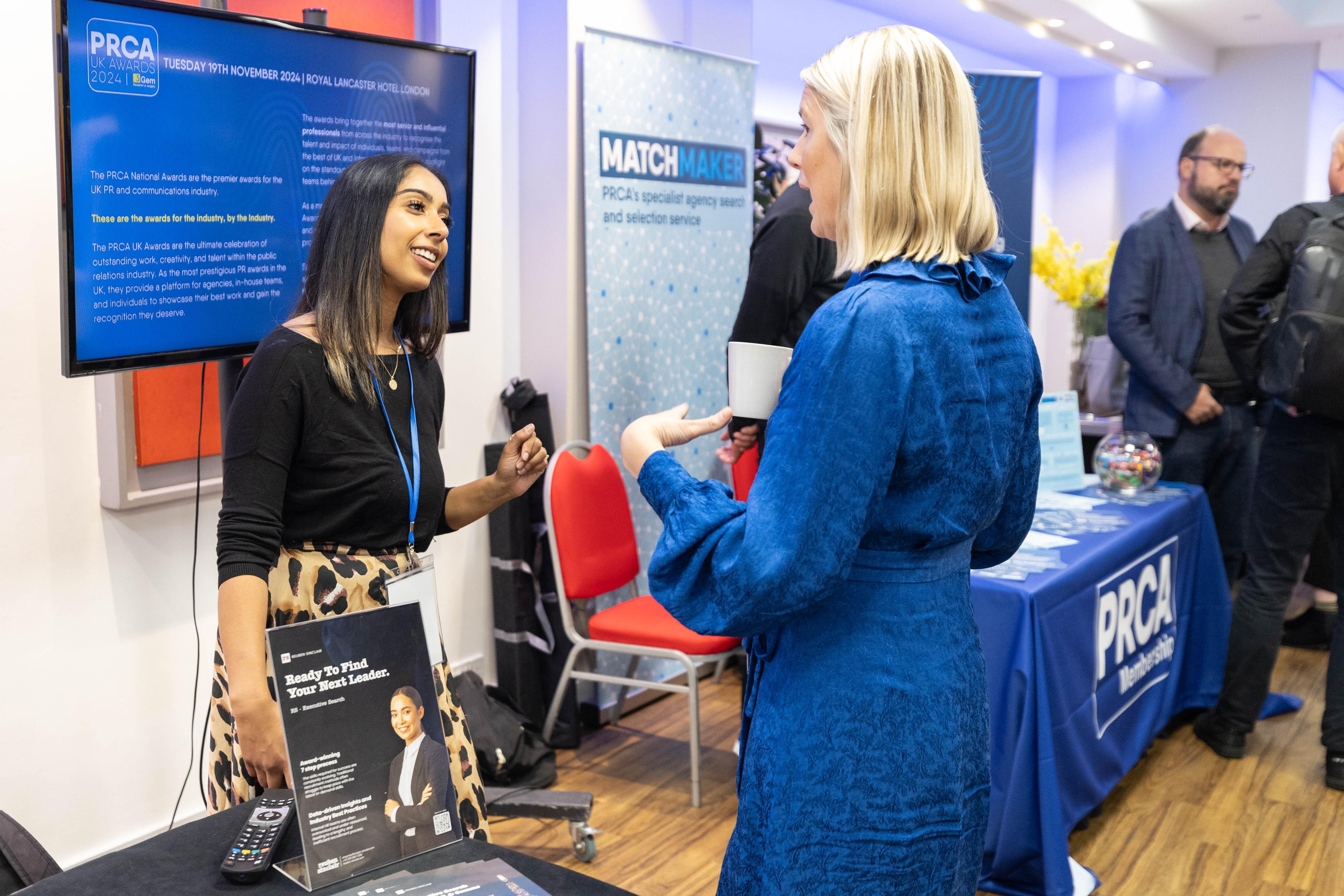 An image of two people having a discussion at a PRCA event