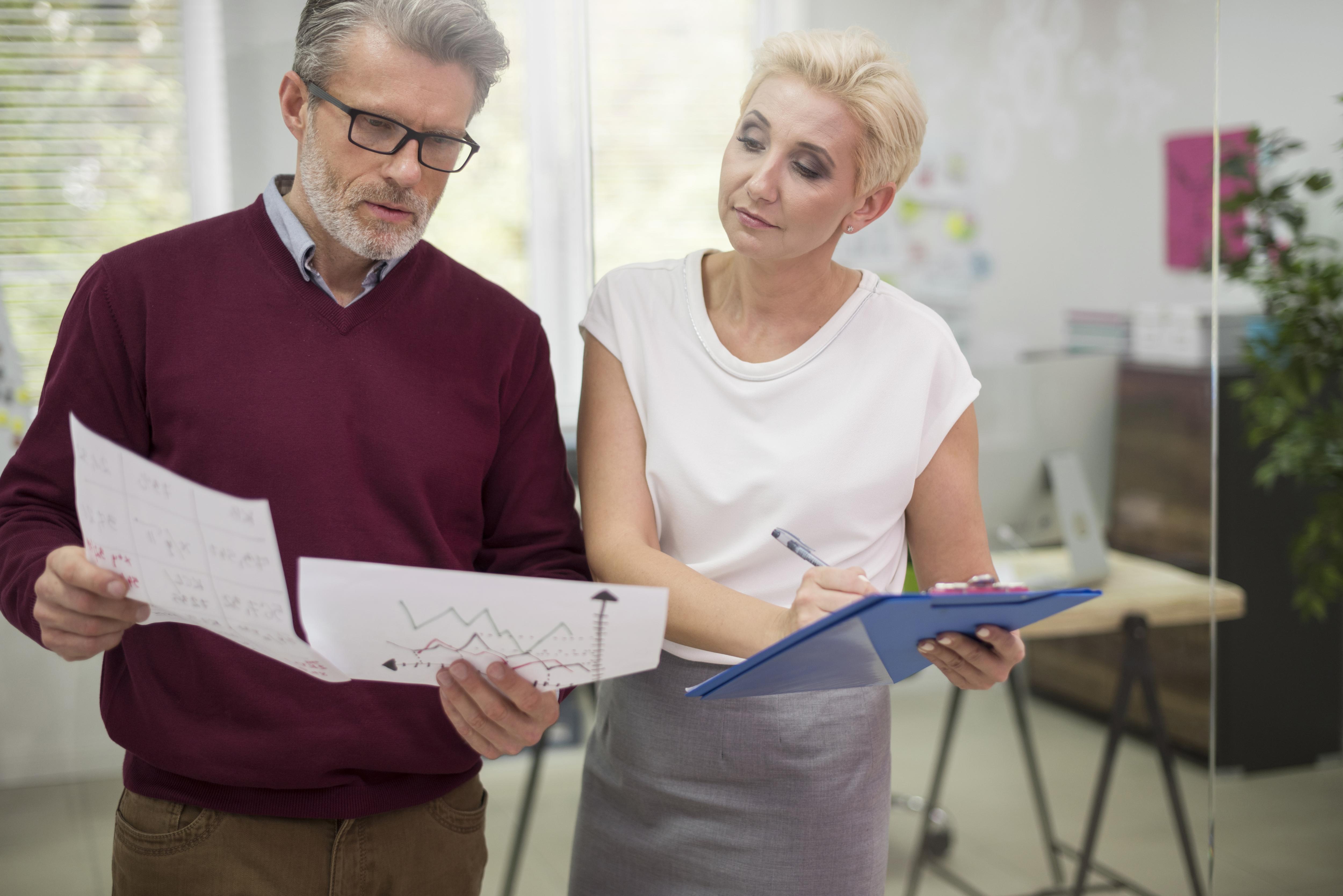 A pair of individuals working together in an office.